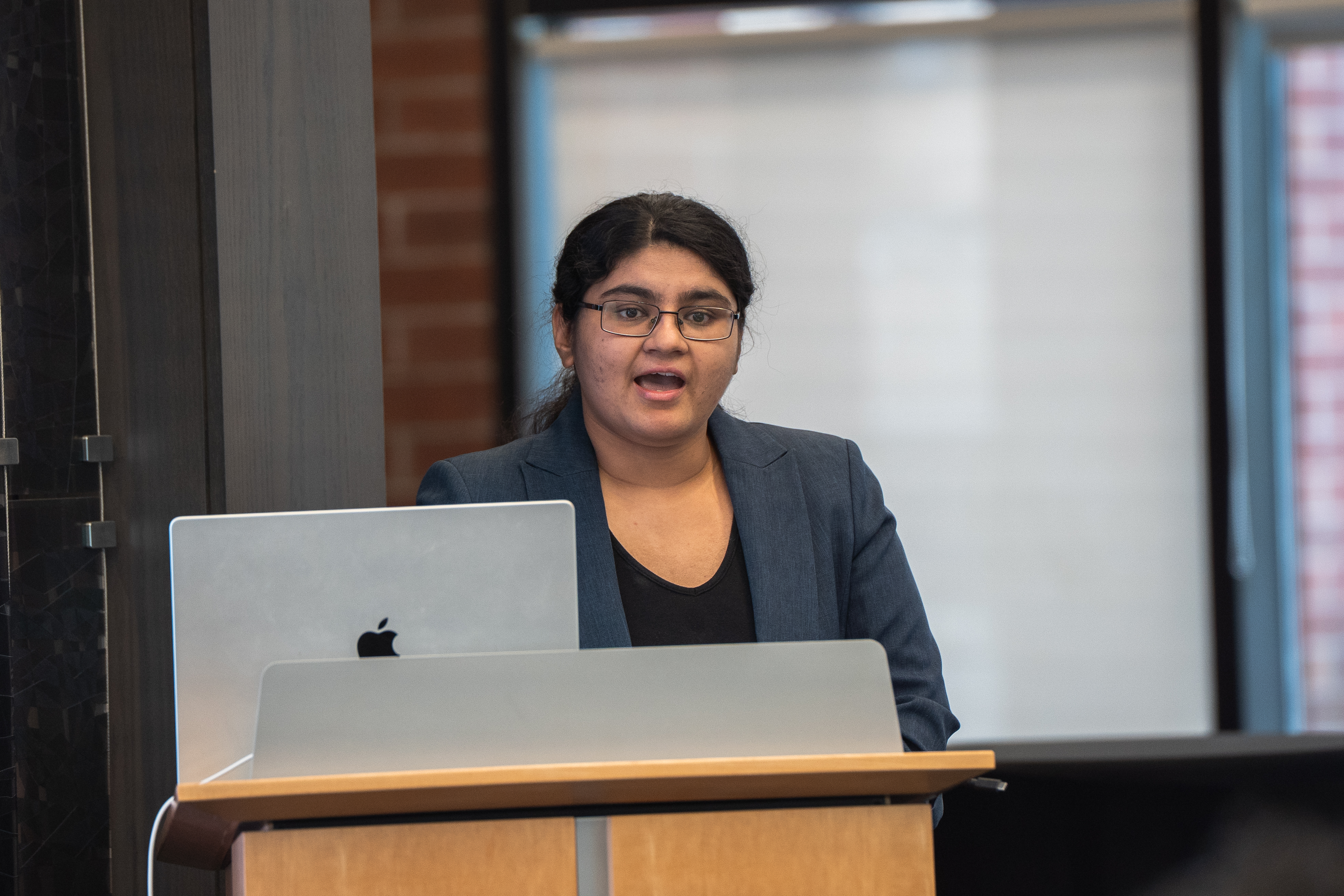 Attrayee Chakraborty at the lectern delivering closing remarks.