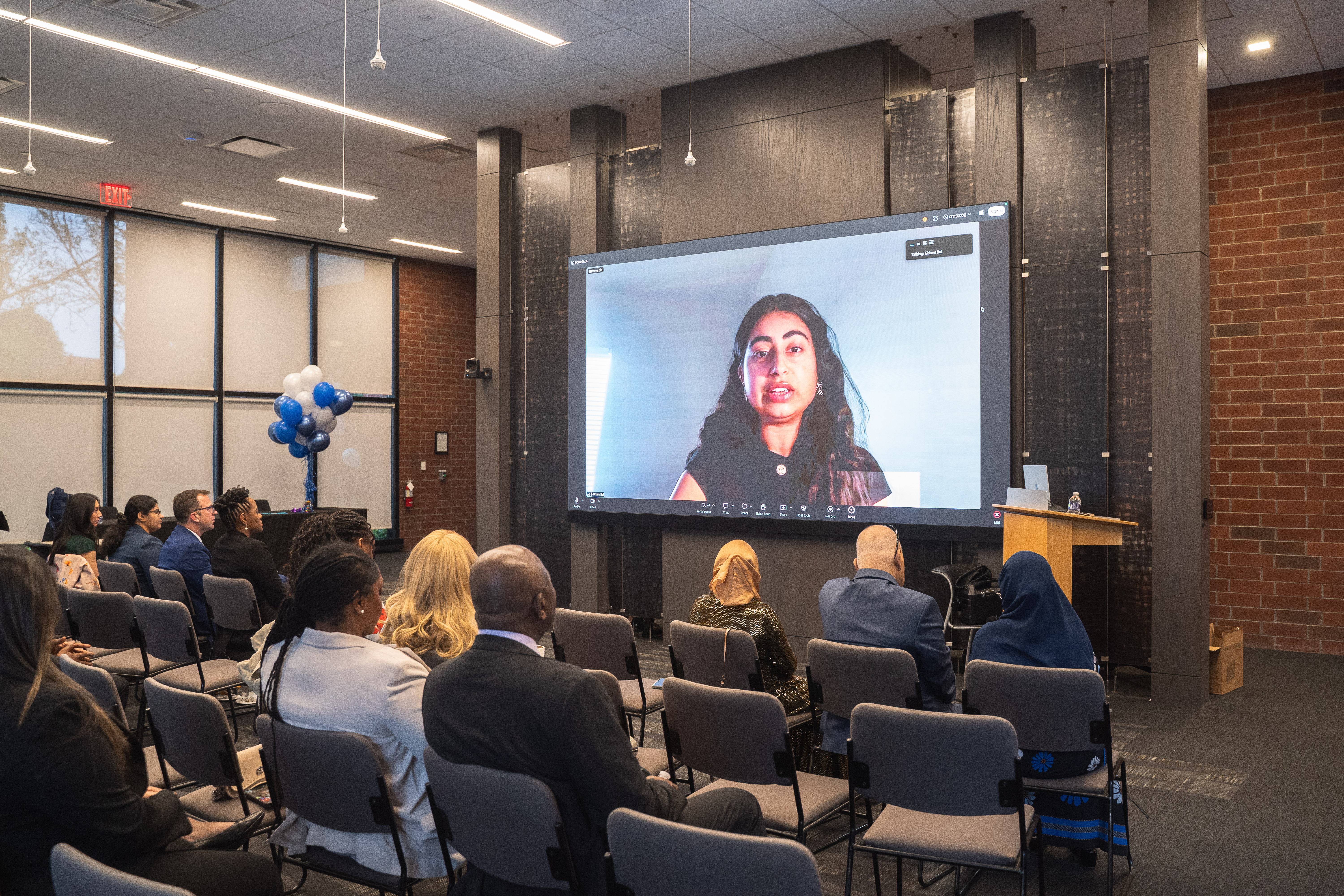 Ekkam Bal at the lectern presenting her Health Justice Scholars entry.