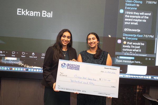 Shriya Veluri and Nanditha Niranjan of UT Health Houston holding an oversized BCPH check for $250.