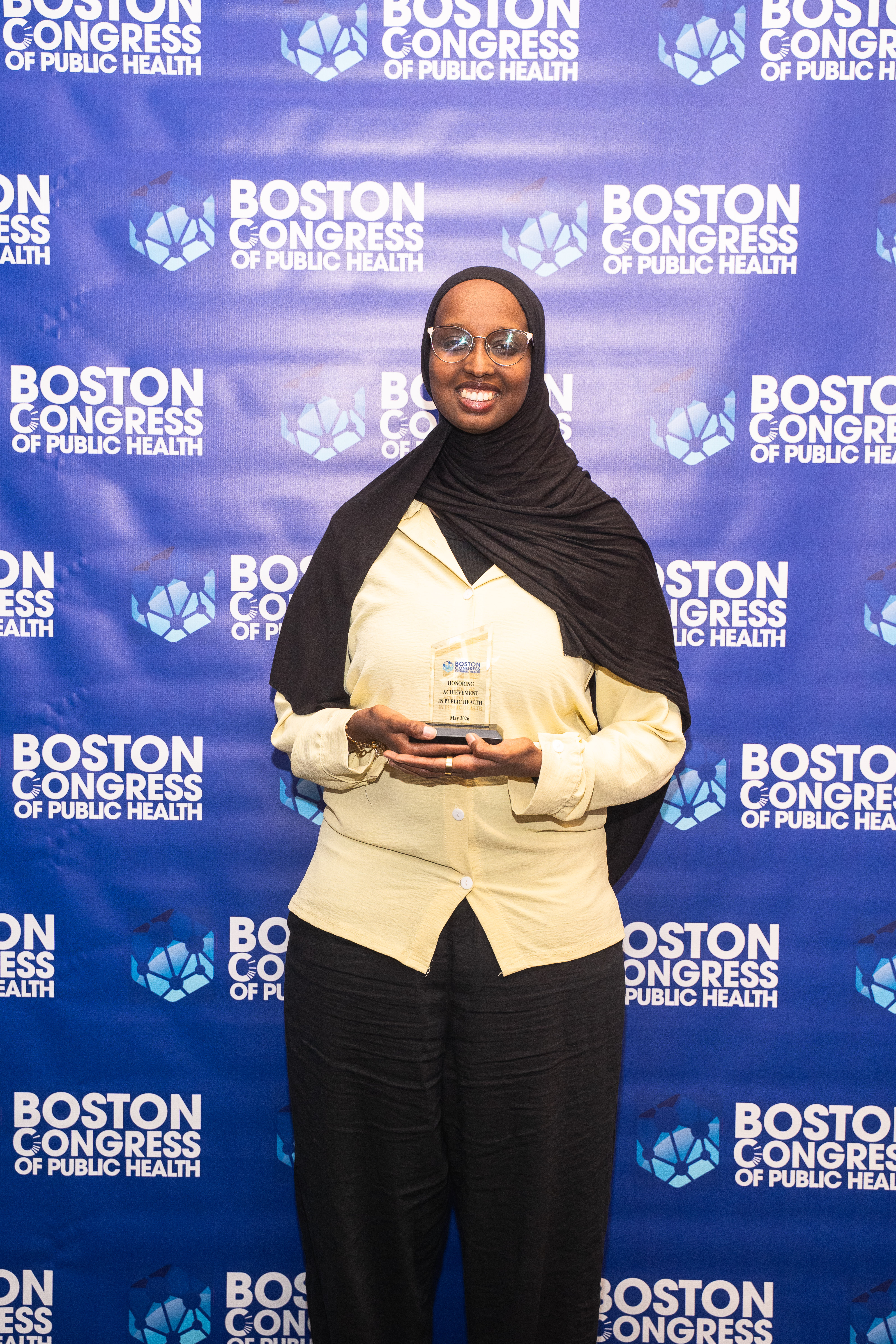 Sirad Hassan, MS, in front of the BCPH step-and-repeat.