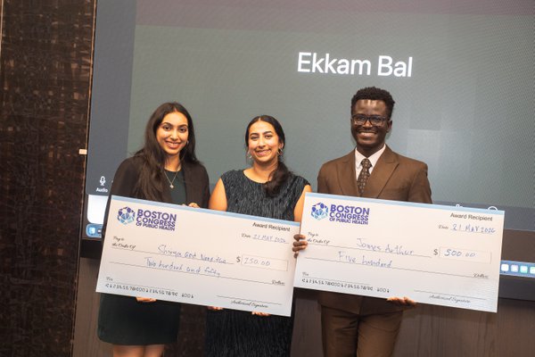 Shriya Veluri, Nanditha Niranjan, and James Arthur holding the Health Justice Scholars Competition prize checks.